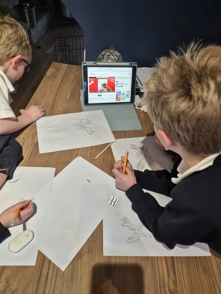Children drawing reindeer together from a video tutorial